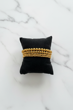 Gold Beaded Bracelets on Marble 2:3