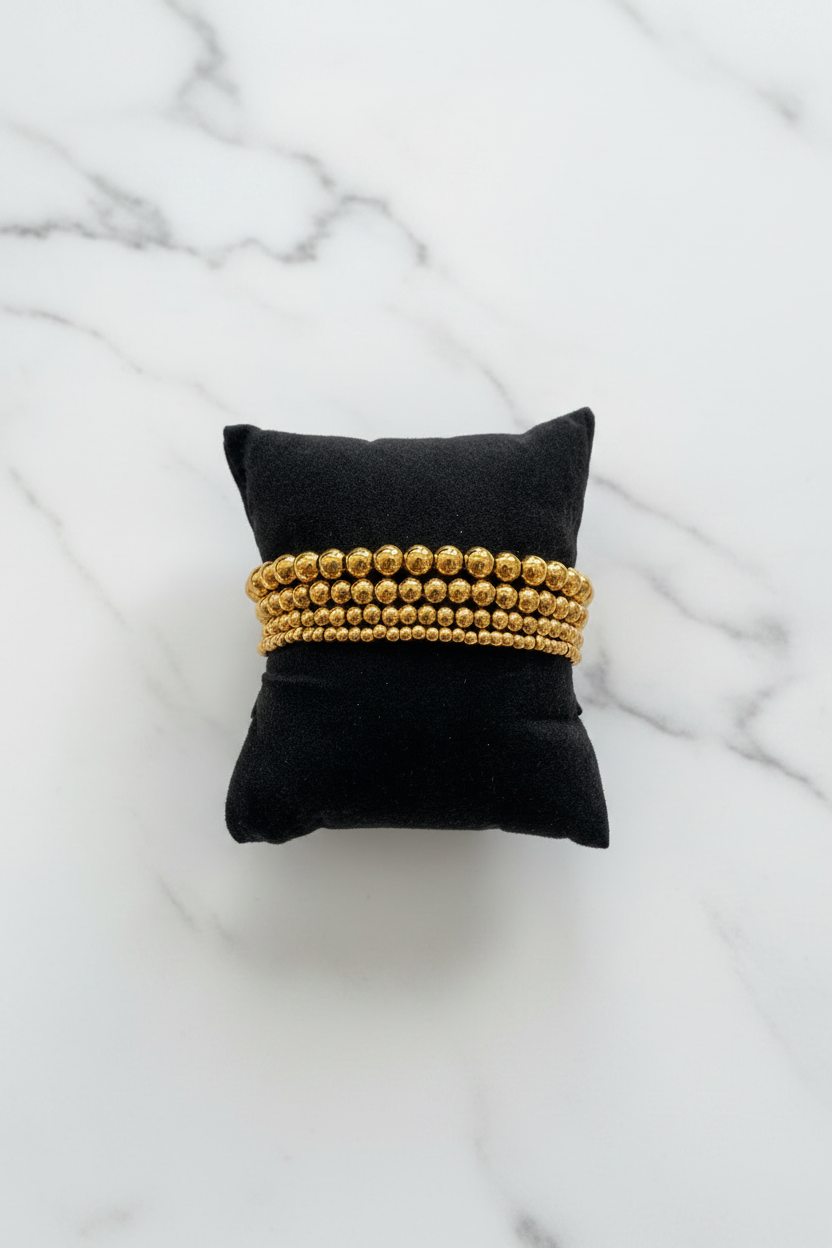 Gold Beaded Bracelets on Marble 2:3